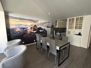 a kitchen with a dining room table and chairs at Valhalla Panorama in Funchal