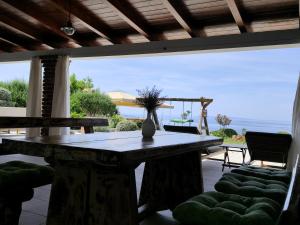 a dining table with a view of the ocean at Apartments Tinjarosa in Mundanije