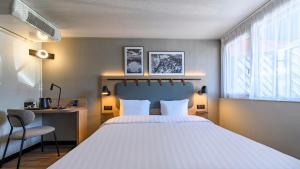 En eller flere senge i et værelse på Campanile PRIME - Nîmes Centre + 30 billeder