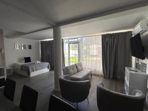 a bedroom with a bed and a couch and a chair at Valhalla Panorama in Funchal
