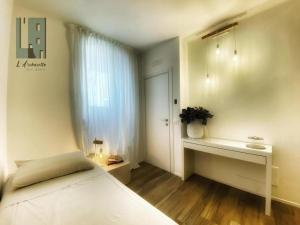 a bedroom with a bed and a desk and a window at L'Archasetta civico 7 Camera singola in Casamassima