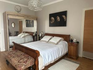 a bedroom with two beds and a mirror at Maison de ville in Saint-Jean-dʼAngély