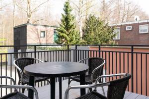 a black table and chairs on a balcony at Park Central Executive Apartments 102 in The Hague