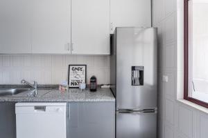 Køkken eller tekøkken på GuestReady - Comfortable Gaia Escape