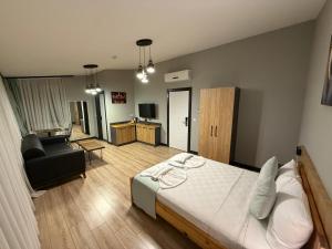 a bedroom with a bed and a living room at Taksim alkan tower residence in Istanbul