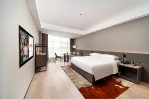 Letto o letti in una camera di Ronghuitong SSAW Hotel