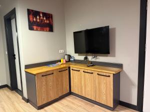 a room with a counter with a television on a wall at Taksim alkan tower residence in Istanbul