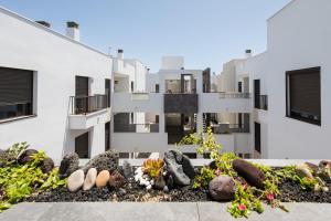 an apartment building with a garden in front of it at Casa Lily in Antigua