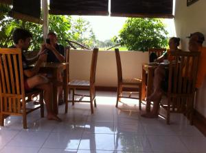 a group of people sitting in chairs at a table at Mesari Homestay in Amed