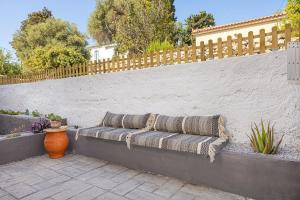 a bench with pillows on it next to a fence at Lotus Apartment in Ríva