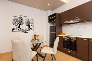 a kitchen with a table and chairs in a room at Lotus Apartment in Ríva