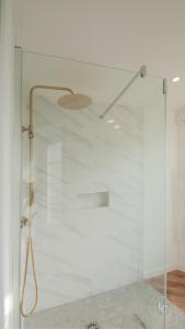 a shower with a glass door in a bathroom at La Maison d’Arc Romantic Spa Escape in Saint-Péravy-la-Colombe