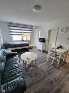 a living room with a couch and a table at Apartment an der Weser in Bremerhaven