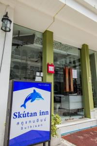 a sign in front of a store with a sign in front at Skutan Inn Sutthisan Nexus Opal in Bangkok