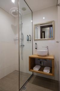 a bathroom with a sink and a glass shower at Villa 1868 in Mithymna