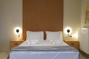 a bedroom with a large bed with two white pillows at Villa 1868 in Mithymna