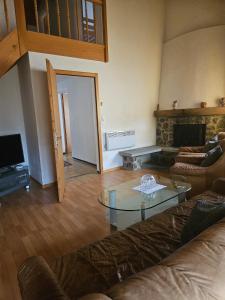 a living room with a couch and a glass table at Cá al Ponte in Bivio +2 photos
