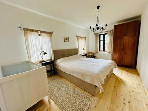 a bedroom with a large bed and a bath tub at The Red Konak in Veliko Tŭrnovo