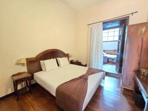 a bedroom with a bed and a large window at Tamahuche Hotel Rural in Vallehermoso