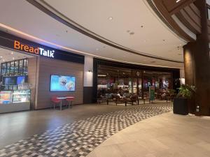 a lobby of a shopping mall with a break walk at Makati Business District Prime Accommodations in Manila