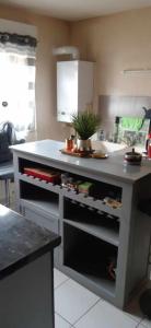 a kitchen with an island with an open drawer at Maison rue Sonia Delaunay LE MANS in Le Mans