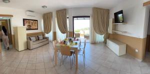a living room with a table and a couch at Villa Blue Horizon in Costa Paradiso