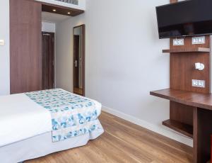 TV a/nebo společenská místnost v ubytování Hotel Olympia Universidades