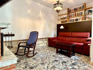 a living room with a red couch and a chair at The Red Konak in Veliko Tŭrnovo