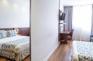 Postel nebo postele na pokoji v ubytování Hotel Olympia Universidades + 37 fotografií
