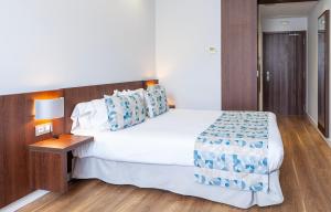 Postel nebo postele na pokoji v ubytování Hotel Olympia Universidades