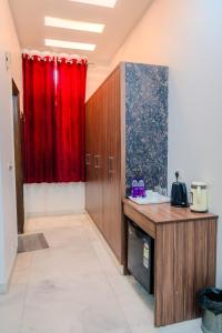 a room with a desk and a red curtain at Peepal Tree Residency in New Delhi