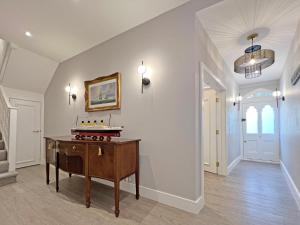 a living room with a table in the middle at Incredible Luxury Windsor Long Walk 4 Bedroom Home With Free Driveway Parking in Windsor +35 photos