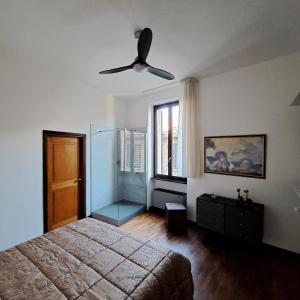 a bedroom with a bed and a ceiling fan at Sansovino Home in Fano +7 photos