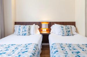 Postel nebo postele na pokoji v ubytování Hotel Olympia Universidades