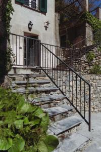 a set of stairs in front of a building with a gate at Residenza Nemus Vinea Mare e Montagna in Graveglia