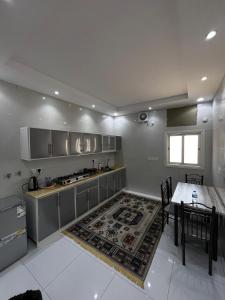 a large kitchen with a table and a table and a tableablish at Yaqoot Al Madina Suites in Al ‘Awālī