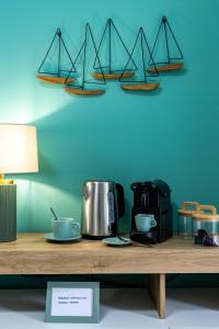 a table with a coffee maker and three sails on a wall at Lake Bike Station - Central Baveno - Free WiFi in Baveno