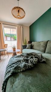 a living room with a bed and a couch at Lychen-Daheim, 2-Zimmer-Apartment im Herzen von Lychen in Lychen