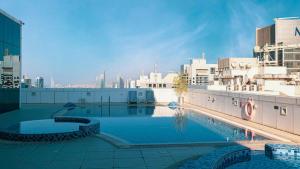 a large pool on top of a building with a city at Modern 1BR in Saba Tower 2 - Prime JLT Location in Dubai
