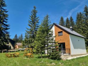 a cabin in the woods with a picnic table and trees at Forest Fox in Žabljak