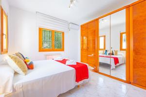 a white bedroom with a bed and a mirror at Villa Mona - PlusHolidays in Ifach +39 photos