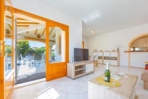 a living room with a couch and a television at Villa Mona - PlusHolidays in Ifach