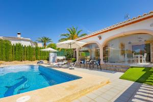 a villa with a swimming pool and a house at Villa Mona - PlusHolidays in Ifach