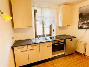 a small kitchen with a sink and a window at Ehemaliges Wein Chateau in Winningen