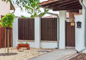 a house with a fence and a gate with a bench at Apartmány Lenkoska in Nový Přerov