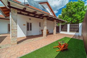 a house with a patio with a table on a lawn at Apartmány Lenkoska in Nový Přerov +113 photos
