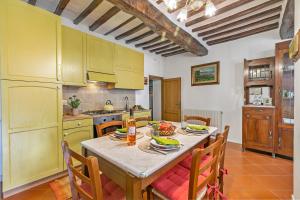 a kitchen with a table with food on it at Borgo Panicale with Shared Pool and Garden in Panicale