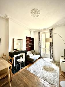 a living room with a couch and a table at Le Cocon - 2 Bedrooms in Grenoble