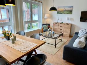 a living room with a table and a couch at Birkennest in Zingst