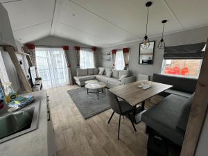 a living room with a couch and a table at Royal Oak Caravan Park in Skegness